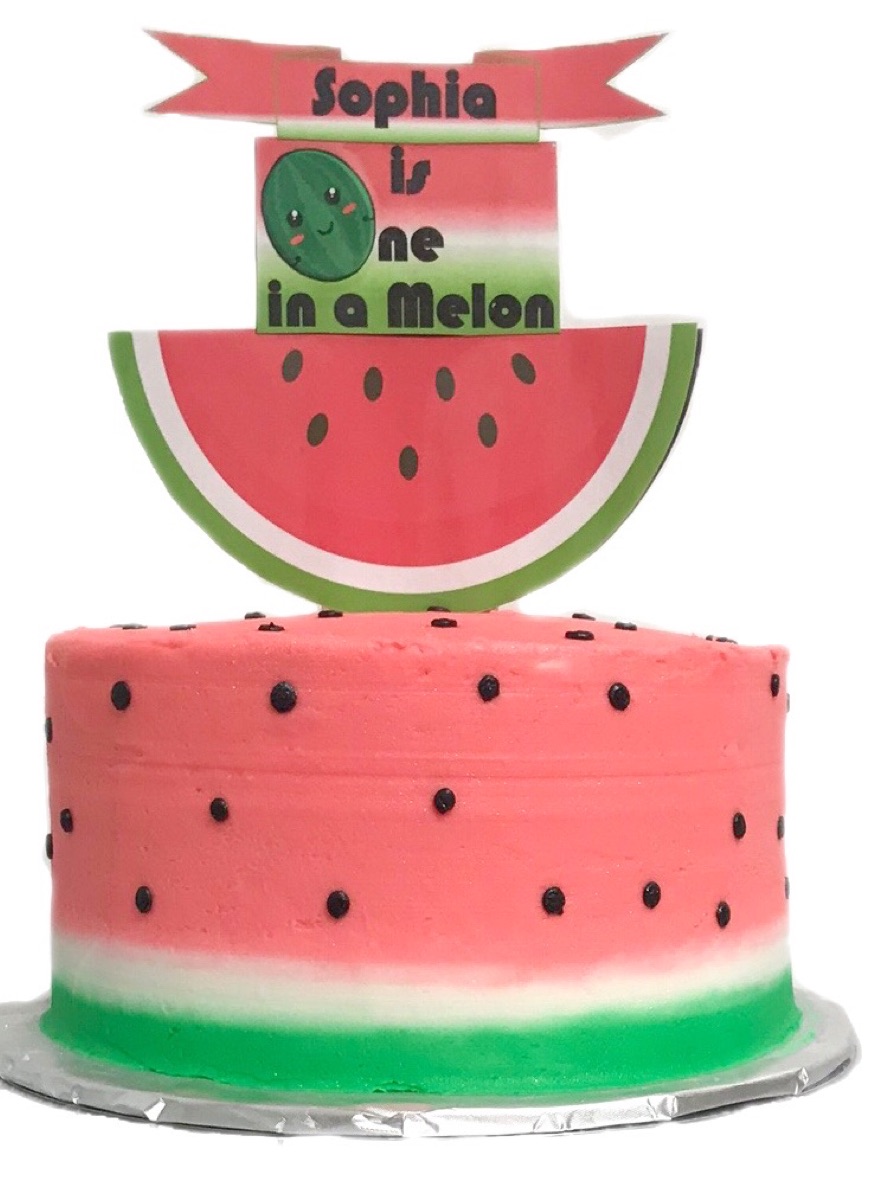 Pink watermelon-themed first-birthday cake with a fun topper