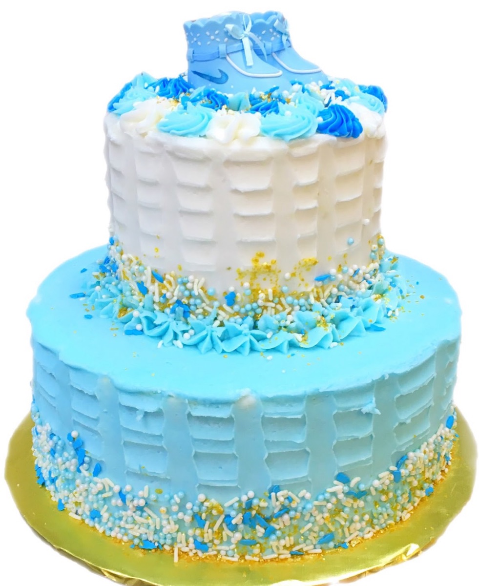 Two-tier blue-and-white baby shower cake with gold sprinkles